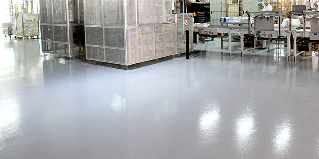 grey coloured industrial epoxy floor in factory manufacturing line